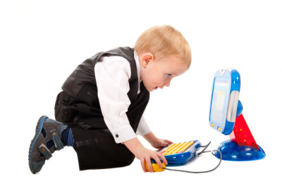 Little boy playing with a toy computer