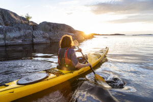 Kayaking on open water in the sunset